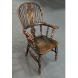 A 19th century beech and elm Windsor stick back armchair with pierced back splat, solid seat, on