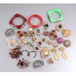 A quantity of costume jewellery to include brooches, bangles and clips.