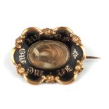 A 19th century yellow metal black enamel and hairwork mourning brooch, 3 by 2.2cms, 5.8g.