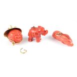 A yellow metal mounted coral charm in the form of a double sided Asian mans face; together with a