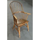 A 19th century beech and elm Windsor stick back armchair with comb back, solid seat, on turned front