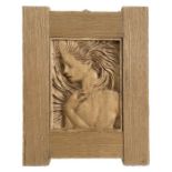 A carved wooden panel depicting a young girl, in an oak frame, overall 28 by 36cms.