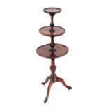 A Georgian style mahogany dumb waiter on turned column and tripod base, 98cms high.