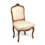 A Louis XVI style salon chair with upholstered back and seat.