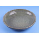 A Chinese Ming dynasty Longquan celadon shallow bowl decorated flowers. 25cm diameter