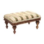 A 19th century giltwood footstool with upholstered seat, 45cms wide.