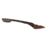 A chip carved tribal water or grain scoop, 64cms long.