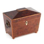 An early 19th century sarcophagus form yew wood two-division tea caddy with basket ring handles,