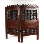 A Middle Eastern hardwood two-fold screen decorated with Islamic script, overall 80 by 74cms.