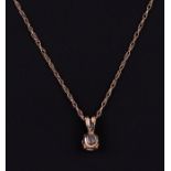 A 15ct gold mounted cubic zirconia pendant on a fine gold chain, 1.4g.