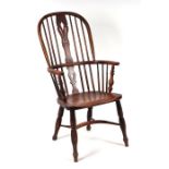 A 19th century beech and elm Windsor stick back armchair with pierced back splat, solid seat, on