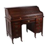 A late 19th / early 20th century oak roll-top desk, the tambour top enclosing a fitted interior