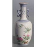 A Chinese republic style famille rose two-handled vase decorated with bamboo and roses, four
