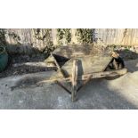 A decorative wooden wheelbarrow, 56cms wide.