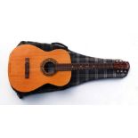 An Italian EKO six-string acoustic guitar, model Studio L with soft carrying case.