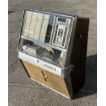 A 1960's Rock-Ola Princess Juke Box, for restoration, 70cms wide; together with a selection 45rpm