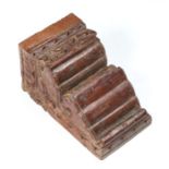 An Indo-Persian carved hardwood bracket with traces of original paint and gilt decoration, 24cms