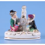 A 19th century Staffordshire pottery spill vase modelled as two boys playing marbles, 11.6cms high.