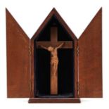 A carved oak crucifix within an oak case, 26cms high.