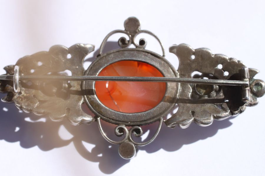 An Austro-Hungarian white metal brooch set with a central oval hardstone cabochon and six pale green - Image 12 of 12