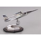 A mid 20th century chrome plated table lighter in the form of a jet aeroplane on a stepped base,