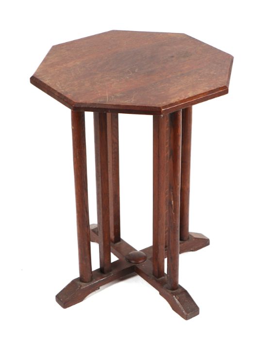 A small octagonal Arts & Crafts oak occasional table, 44cms wide.