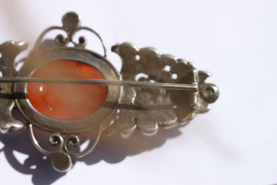 An Austro-Hungarian white metal brooch set with a central oval hardstone cabochon and six pale green - Image 10 of 12