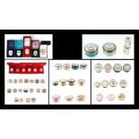 A large collection of Halcyon Days enamel boxes to include Christmas boxes, egg shaped boxes and