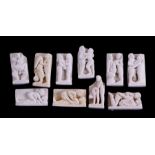 A group of miniature plaster figural plaques depicting erotic scenes, largest 4cms high (10).