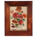 A needlework picture depicting a still life of chrysanthemums in a vase, framed & glazed, 24 by