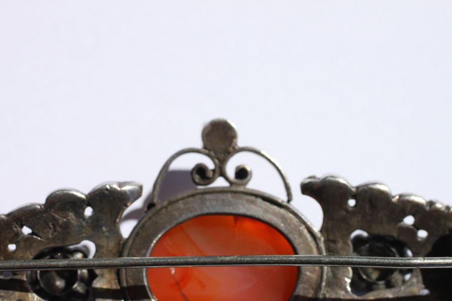 An Austro-Hungarian white metal brooch set with a central oval hardstone cabochon and six pale green - Image 2 of 12