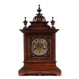 A late 19th century German walnut cased mantle clock, 26cms wide.