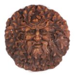 A pottery wall plaque depicting the Green Man, 36cms diameter.