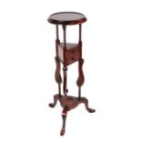 A reproduction mahogany wig stand with two short drawers and tripod base, 88cms high.