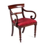 A 19th century mahogany desk chair with scroll arms, drop-in seat and turned front legs.