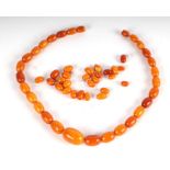 A butterscotch graduated bead necklace; and other loose beads.