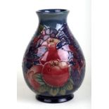 A William Moorcroft Pomegranate, Grape & Birds pattern squat baluster form vase with tube lined
