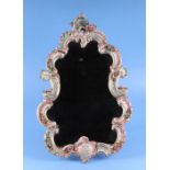 A Dresden style porcelain strut mirror of cartouche form, decorated with encrusted flowers, 38cms