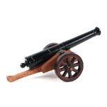 A large desk top cannon with a 37cms (14.5ins) long alloy barrel mounted on a wooden carriage and