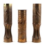 A matching pair of WW1 trench art fluted brass shell cases decorated with doves and foliage. Overall