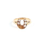 A 15ct gold seed pearl set horseshoe ring (lacking two pearls), approx UK size 'J', 2.9g.