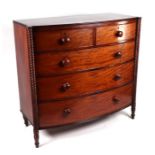 An early 19th century bowfront mahogany chest of two short and three graduated long drawers, on