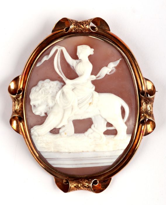 A 19th century yellow metal mounted large cameo brooch depicting a classical woman riding a lion,