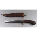 An Indian dagger with carved hardwood scabbard and handle, 34cms long.