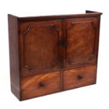 A 19th century mahogany cupboard, the pair of panelled doors enclosing a fitted interior, above