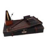 A Lindemann's cased zither; together with a French metronome (2).