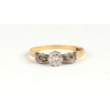 An 18ct gold and platinum three-stone diamond ring, approx UK size 'O', 2.2g.