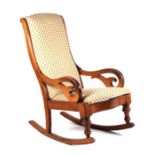 A late 19th century walnut rocking chair with upholstered back and seat and scroll arms.
