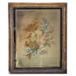 A 19th century silk work panel depicting flowers, framed & glazed in a verre eglomise gilt frame, 31