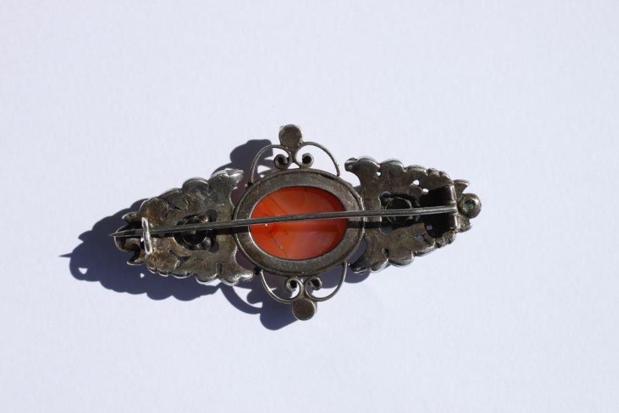 An Austro-Hungarian white metal brooch set with a central oval hardstone cabochon and six pale green - Image 5 of 12